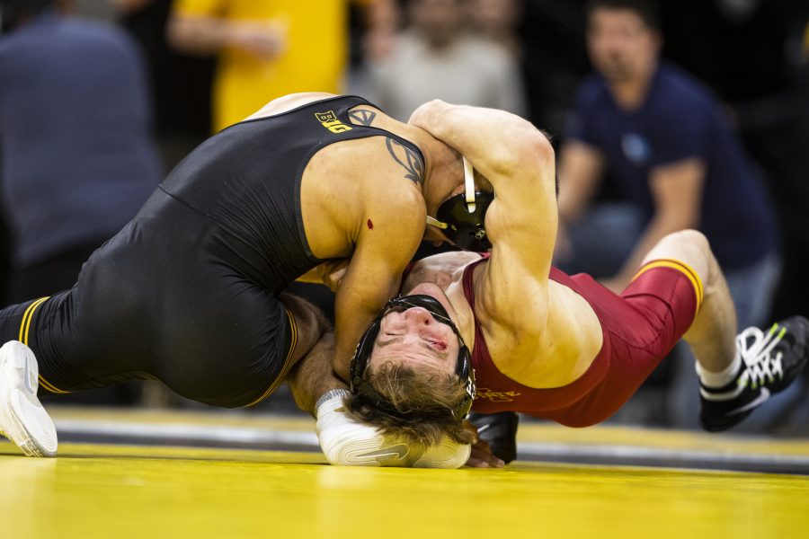 Iowa States No. 7 Casey Swiderski pulls down Iowa’s No. 3 141-pound Real Woods during a wrestling meet between No. 2 Iowa and No. 7 Iowa State at Carver-Hawkeye Arena in Iowa City on Sunday, Dec. 4, 2022. Woods defeated Swiderski by decision, 4-2. The Hawkeyes defeated the Cyclones, 18-15. 