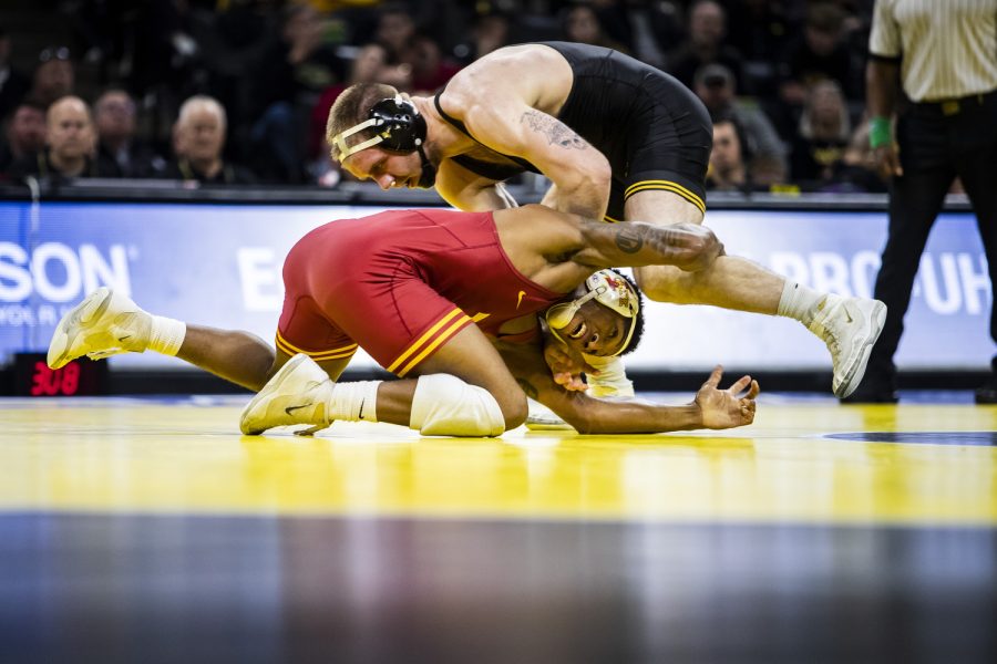 Iowa States No. 3 165-pound David Carr grabs Iowa’s No. 15 165-pound Patrick Kennedy during a wrestling meet between No. 2 Iowa and No. 7 Iowa State at Carver-Hawkeye Arena in Iowa City on Sunday, Dec. 4, 2022. Carr defeated Kennedy, 10-4. The Hawkeyes defeated the Cyclones, 18-15. 
