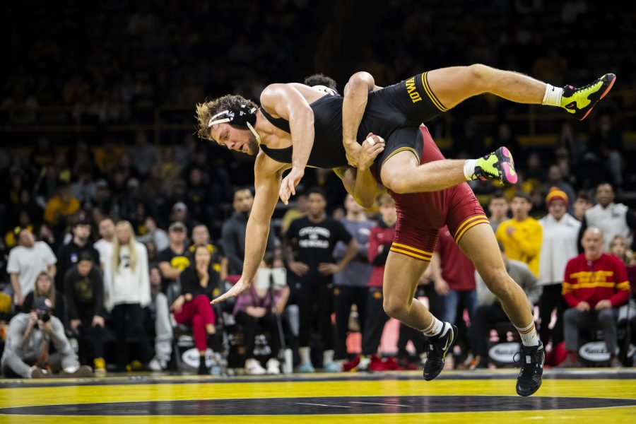 Iowa State's No. 6 197-pound Younger Bastida takes down Iowa’s No. 5 197-pound Jacob Warner during a wrestling meet between No. 2 Iowa and No. 7 Iowa State at Carver-Hawkeye Arena in Iowa City on Sunday, Dec. 4, 2022. Bastida defeated Warner, 4-3. The Hawkeyes defeated the Cyclones, 18-15. 