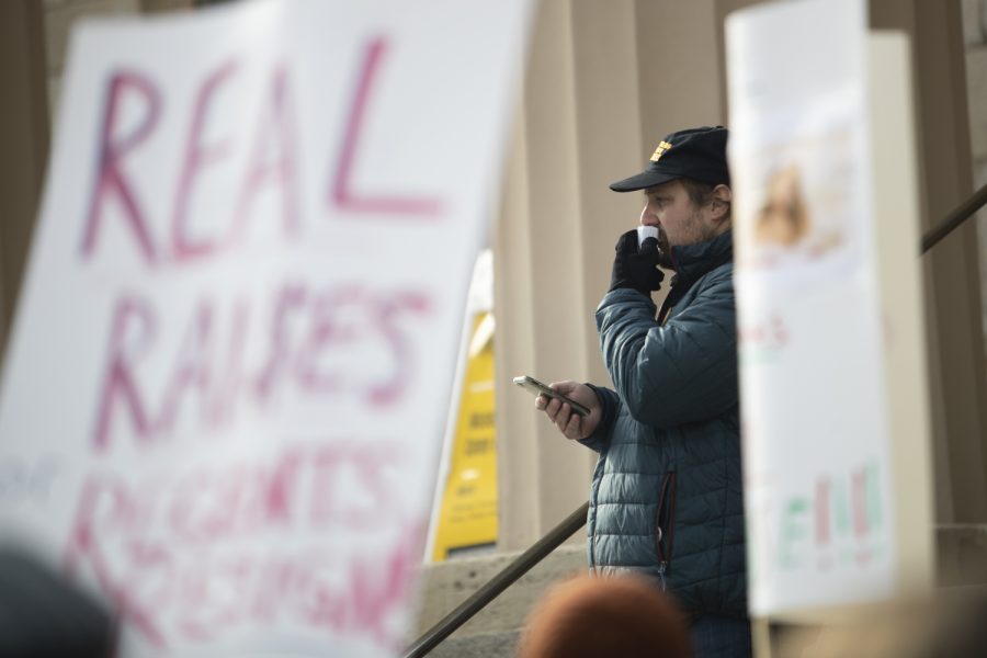 A speaker talks during a COGS protest on the Old Capitol steps Thursday, Dec. 8, 2022.