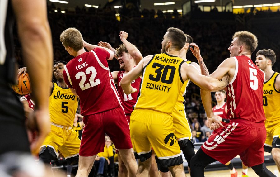 Iowa guard Dastone Bowen reaches for a rebound during a men’s basketball game between Iowa and Wisconsin at Carver-Hawkeye Arena in Iowa City on Sunday, Dec. 11, 2022. The matchup was back and forth for its entirety. Both Iowa and Wisconsin scored 27 points in the first half and 33 in the second. The Badgers defeated the Hawkeyes in overtime, 78-75.