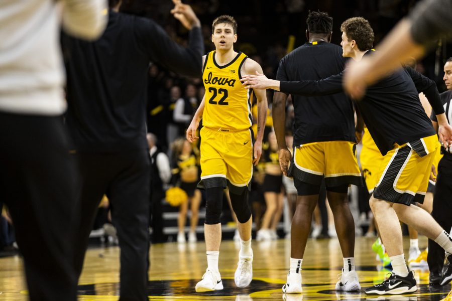 Iowa forward Patrick McCaffery walks toward his team after a timeout call during a men’s basketball game between Iowa and Wisconsin at Carver-Hawkeye Arena in Iowa City on Sunday, Dec. 11, 2022. The Badgers defeated the Hawkeyes in overtime, 78-75.