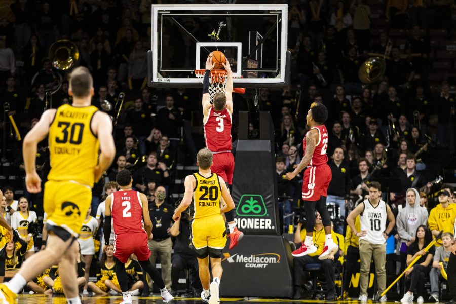 Wisconsin guar Connor Essegian dunks the ball during a men’s basketball game between Iowa and Wisconsin at Carver-Hawkeye Arena in Iowa City on Sunday, Dec. 11, 2022. Essegian scored 14 points for Wisconsin, and scored the last two points in the matchup, securing a win for the Badgers. Wisconsin defeated Iowa in overtime, 78-75.