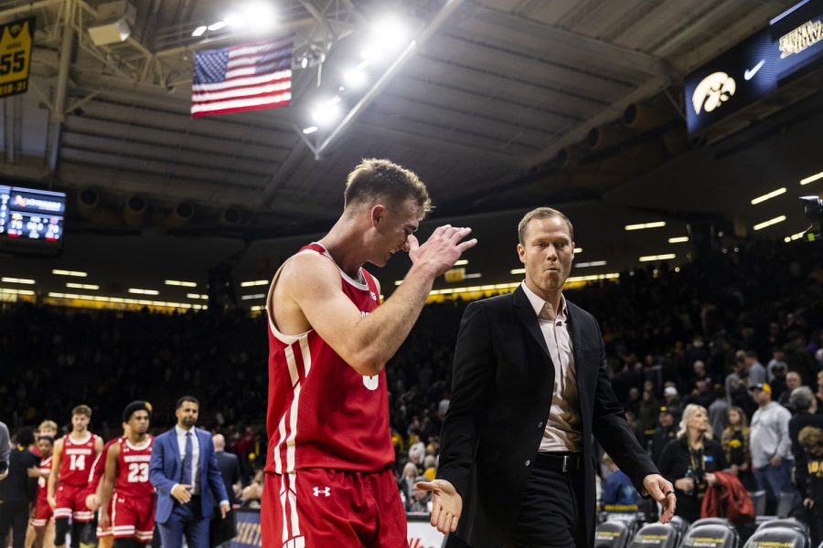 Wisconsin forward Tyler Wahl high-fives associate head coach Joe Krabbenhoft during a men’s basketball game between Iowa and Wisconsin at Carver-Hawkeye Arena in Iowa City on Sunday, Dec. 11, 2022. The Badgers defeated the Hawkeyes in overtime, 78-75.