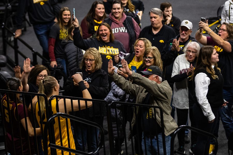 Minnesota guard Maggie Czinano and Iowa center Monika Czinano celebrate with their family after a womens basketball game between Iowa and Minnesota at Carver-Hawkeye Arena in Iowa City on Saturday, Dec. 10, 2022. The Hawkeyes defeated the Gophers, 87-64.