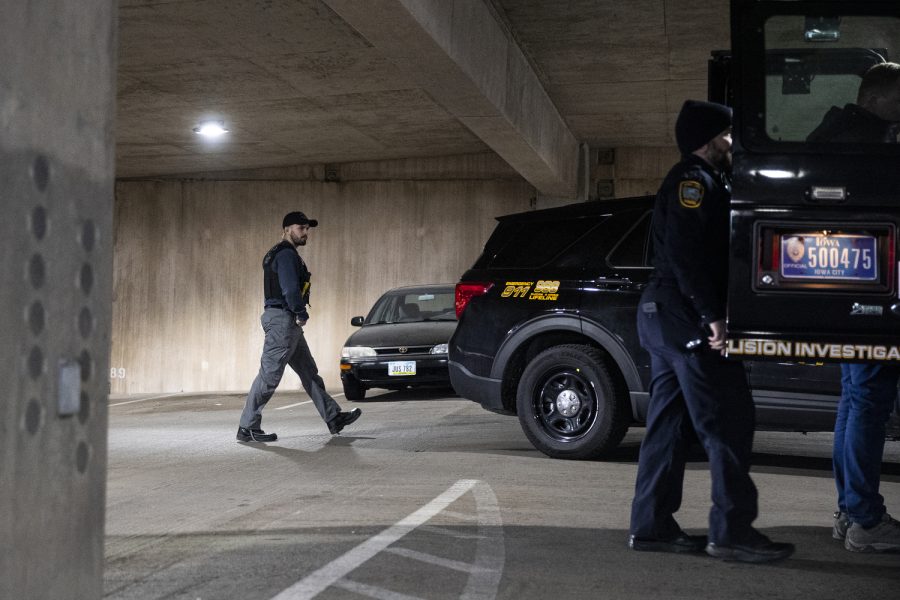 Iowa City police officer Alec Fjelstul works the scene of the crime after Iowa City Police Department was called to the Court Street parking ramp for what started as a welfare check in downtown Iowa City on Monday, Dec. 12, 2022. According to a UI Police affidavit, officers received a third-party report that a woman had been forced against her will to go to the bus station by her husband, who allegedly took her from a Cedar Rapids location on Sunday night. After police arrived, Cardale Hunter, 33, pulled out a gun and used the woman as a shield while holding her at gunpoint. According to the City of Iowa City press release, the situation was resolved after the man shot himself, but no other injuries have been reported. Hunter is in stable condition. Hunter is facing charges of second-degree kidnapping, possession of a firearm by a felon, going armed with intent, domestic abuse while displaying a weapon, and child endangerment, according to a UI police release.