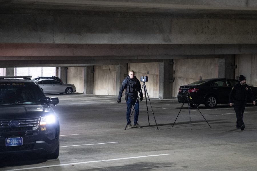 Iowa City Police Department detective Eric Nieland sets up a scan at the scene of the crime after ICPD was called to the Court Street parking ramp for what started as a welfare check in downtown Iowa City on Monday, Dec. 12, 2022. According to a UI Police affidavit, officers received a third-party report that a woman had been forced against her will to go to the bus station by her husband, who allegedly took her from a Cedar Rapids location on Sunday night. After police arrived, Cardale Hunter, 33, pulled out a gun and used the woman as a shield while holding her at gunpoint. According to the City of Iowa City press release, the situation was resolved after the man shot himself, but no other injuries have been reported. Hunter is in stable condition. Hunter is facing charges of second-degree kidnapping, possession of a firearm by a felon, going armed with intent, domestic abuse while displaying a weapon, and child endangerment, according to a UI police release.