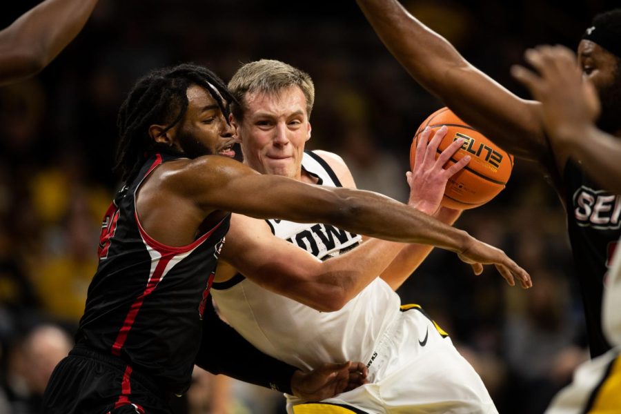 Iowa sophomore forward Payton Sandfort battles a Southeast Missouri State defensder during a basketball game between the Hawkeyes and Redhawks on Saturday Dec. 17 at Carver-Hawkeye Arena. Sandfort scored a career-high 24 points on 9-of-13 shooting as Iowa defeated Southeast Missouri State, 106-75. 
