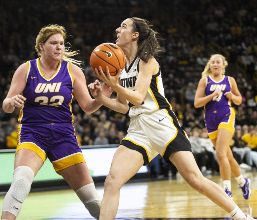Iowa junior guard Caitlin Clark drives to the rim with the ball against a University of Northern Iowa defender during a womens basketball game between the Hawkeyes and Panthers on Sunday, Dec. 18 at Carver-Hawkeye Arena. Clark finished with 26 points and shot 13-of-14 from the free-throw line. 