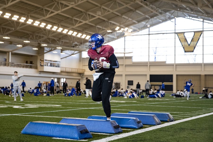 Kentucky quarterback Deuce Hogan performs a drill during a 2022 TransPerfect Music City Bowl Kentucky football practice at Vanderbilt in Nashville, Tenn., on Tuesday, Dec. 27, 2022. Hogan, after entering the transfer portal in the middle of the season at Iowa, transferred to Kentucky after last season. Hogan announced a transfer shortly following Iowa head coach Kirk Ferentz’ remarks in a postgame press conference of the 28-21 win over Nebraska last year. The Iowa quarterback room, at the time, had injury and illness. Ferentz said, “I didnt know who the hell was going to start [before the 2021 Nebraska game]. If it was Deuce, with all due respect to Deuce, I might have stayed in Iowa City. Im joking, but anyway. Thats not a pleasant thought going to your third guy at this point.”
