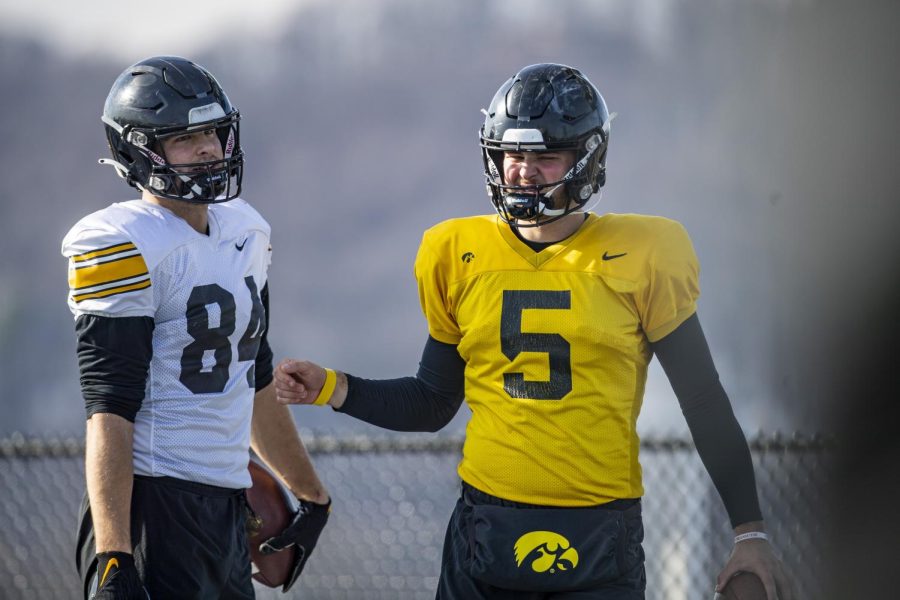 Iowa football tight end Sam LaPorta talks with quarterback Joe Labas at  practice for the Music City Bowl at Franklin Road Academy in Nashville on Dec. 27, 2022. LaPorta will serve as an emergency backup quarterback for the bowl.