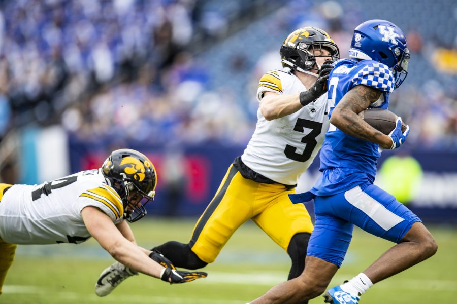 Iowa defensive back Cooper Dejean tackles Kentucky wide receiver Barion Brown during the 2022 TransPerfect Music City Bowl at Nissan Stadium in Nashville on Saturday, Dec. 31, 2022. (Grace Smith/The Daily Iowan)
