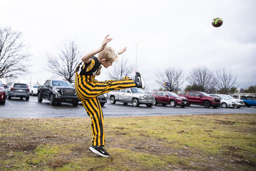 Kasyn Weig kicks a football during a tailgate before a game between Iowa and Kentucky at Nissan Stadium in Nashville on Saturday, Dec. 31, 2022. The Hawkeyes matchup with the Wildcats at 11 a.m.