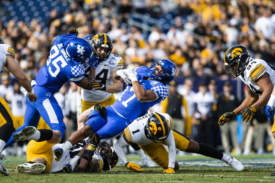 Iowa linebacker Jack Campbell and defensive back Xavier Nwankpa combine to tackle Kentucky running back JuTahn McClain during the 2022 TransPerfect Music City Bowl between Iowa and Kentucky at Nissan Stadium in Nashville. Campbell recorded 10 tackles, including a sack. The Hawkeyes defeated the Wildcats, 21-0.