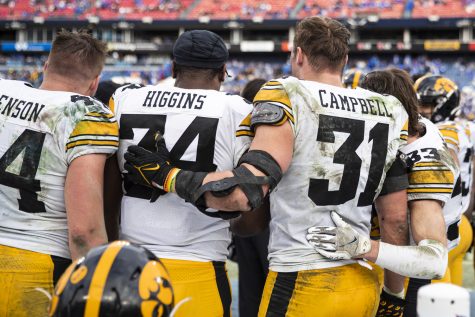 Iowa linebackers Seth Benson, Jay Higgins, and Jack Campbell pose for a photo with defensive back Riley Moss during the 2022 TransPerfect Music City Bowl between Iowa and Kentucky at Nissan Stadium in Nashville. Campbell plans to enter the NFL Draft this year. The Hawkeyes defeated the Wildcats, 21-0.