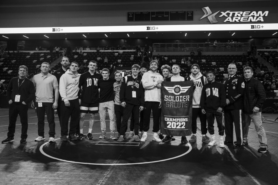 The Iowa Men’s wrestling team poses for a photo after winning the 2022 Soldier Salute College Wrestling Tournament at Xtream Arena in Coralville, Iowa on Friday, Dec. 30, 2022.