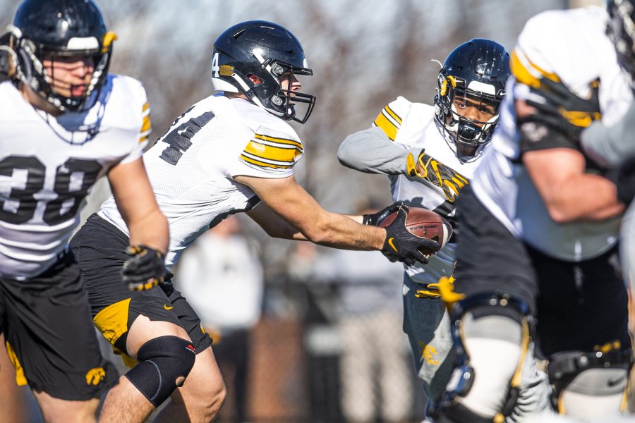 Iowa tight end Sam LaPorta hands the ball off to Iowa running back Leshon Williams in a practice play during a 2022 Transperfect Music City Bowl Iowa football practice at Franklin Road Academy in Nashville, Tenn., on Wednesday, Dec. 28, 2022. 