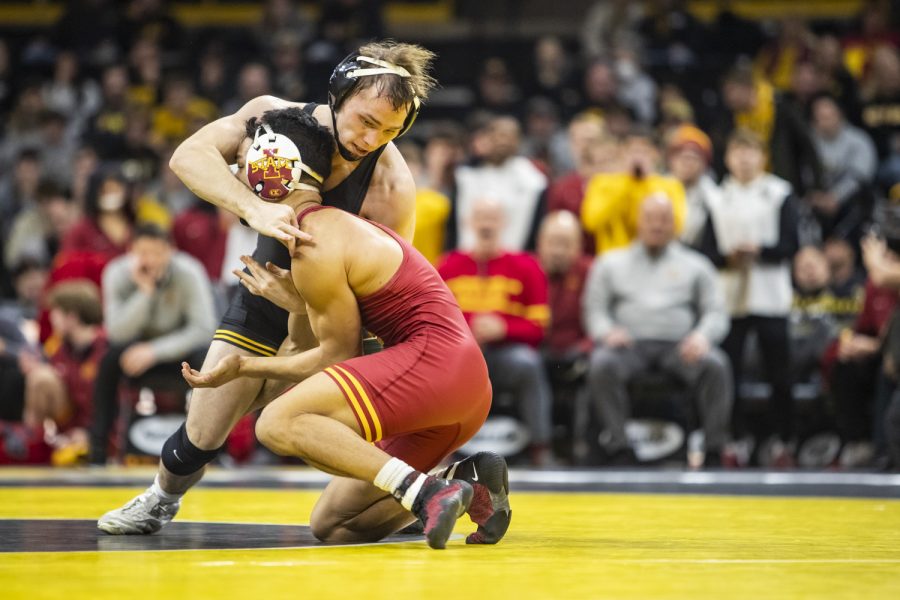 Iowa's No. 1 125-pound Spencer Lee grapples with Iowa State's 125-pound Corey Cabanban during a wrestling meet between No. 2 Iowa and No. 7 Iowa State at Carver-Hawkeye Arena in Iowa City on Sunday, Dec. 7, 2022. Lee made his season debut and defeated Cabanban 16-5.