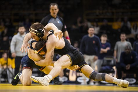 Iowa’s No. 12 165-pound Patrick Kennedy shoots for a takedown on Illinois No. 16 165-pound Danny Braunagel during a wrestling meet between No. 2 Iowa and Illinois at Carver-Hawkeye Arena in Iowa City on Friday, Jan. 6, 2023.  Kennedy defeated Braunagel by major decision, 16-13. The Hawkeyes defeated the Illini, 25-19.