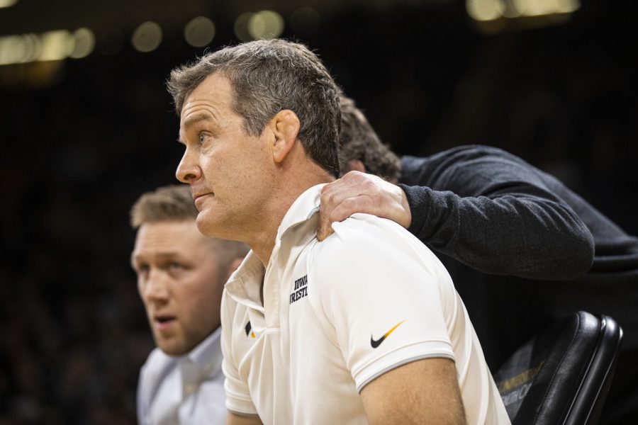 Iowa head coach Tom Brands watches action while Iowa associate head coach Terry Brands grabs Tom’s shoulder during a wrestling meet between No. 2 Iowa and Illinois at Carver-Hawkeye Arena in Iowa City on Friday, Jan. 6, 2023. The Hawkeyes defeated the Illini, 25-19.