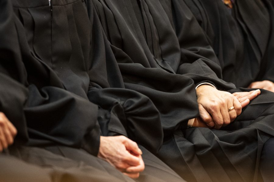 Iowa Supreme Court Justices fold their hands while watching Iowa Supreme Court Chief Justice Susan Christensen deliver a speech during the 2023 State of the Judiciary at the Iowa State Capitol in Des Moines on Wednesday, Jan. 11, 2023.
