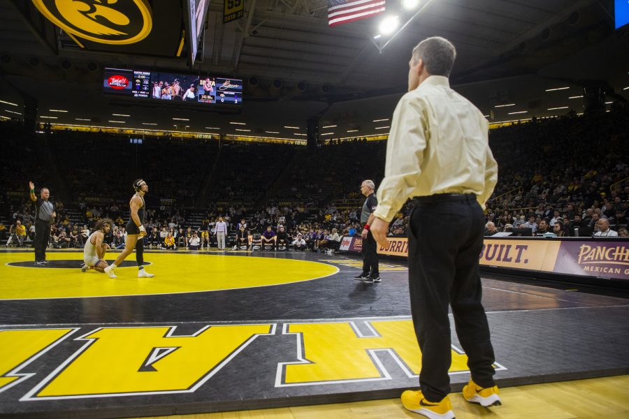 Iowa head coach Tom Brands watches a 141-pound match between No.2 Real Woods and No.6 Frankie Tal-Scharar during a dual between Iowa and Northwestern at Carver-Hawkeye Arena in Iowa City on Jan. 14, 2023. The Hawkeyes defeated the Wildcats, 27-9.