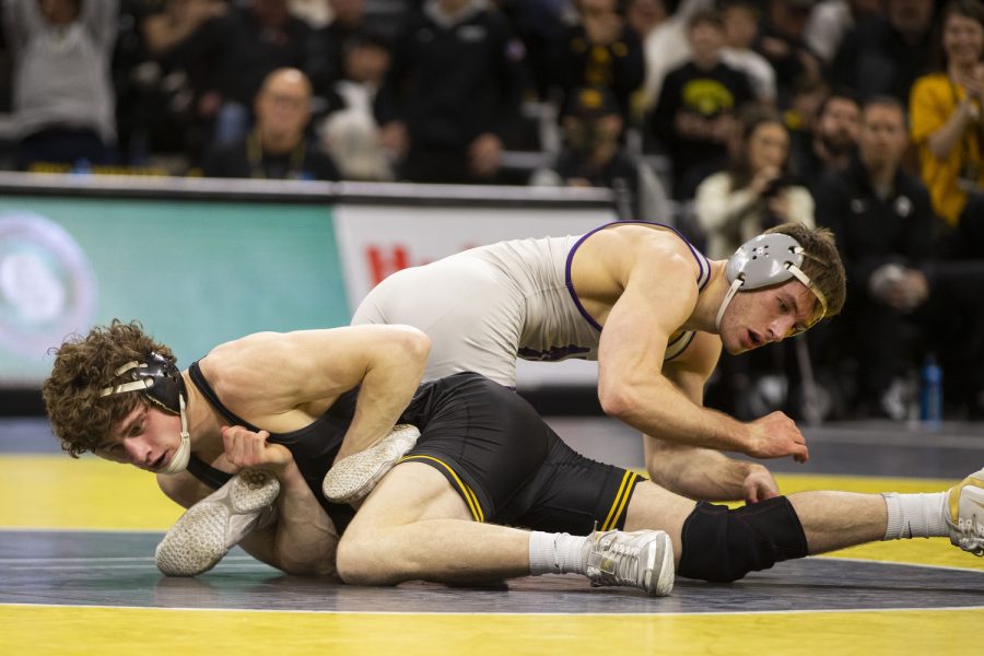 Iowa’s No.16 157-pound Cobe Siebrecht wrestles Northwestern’s No. 9 Trevor Chumbley during a dual between Iowa and Northwestern at Carver-Hawkeye Arena in Iowa City on Jan. 14, 2023. The Hawkeyes defeated the Wildcats, 27-9. Siebrecht defeated Chumbley, 6-3.