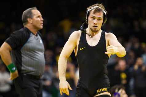 Iowa’s top-ranked 125-pound Spencer Lee walks off the mat after pinning Northwestern’s No. 3 Michael DeAugustino during a dual between Iowa and Northwestern at Carver-Hawkeye Arena in Iowa City on Jan. 14, 2023. The Hawkeyes defeated the Wildcats, 27-9.