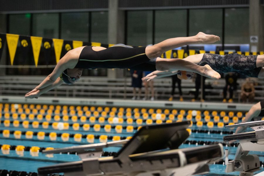 Iowa swimmer Meredith O’Malley dives into the pool at the start of the 1650 yard freestyle event during a swim and dive meet between Iowa and Illinois in Iowa City on Friday, Jan 13, 2023. The Fighting Illini won the duel meet against the Hawkeyes, 46-45.