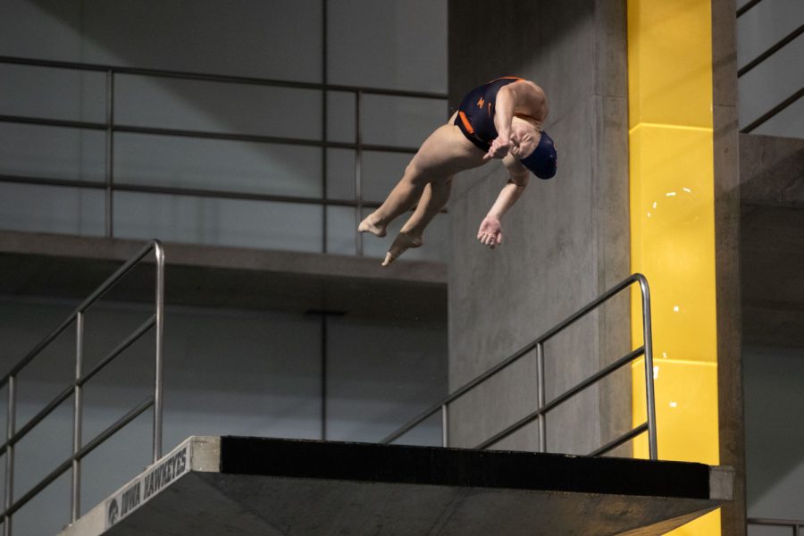 Illinois diver Abby Manos twists during a dive during a swim and dive meet between Iowa and Illinois in Iowa City on Friday, Jan 13, 2023. The Fighting Illini won the duel meet against the Hawkeyes, 46-45.