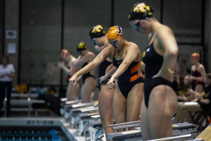 Illinios swimmer Suvana Baskar steps up to the blocks and prepares for the 400 yard medley relay during a swim and dive meet between Iowa and Illinois in Iowa City on Friday, Jan 13, 2023. The Fighting Illini won the duel meet against the Hawkeyes, 46-45.