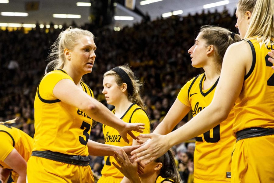 Iowa guard Sydney Affolter high-fives her teammates during a women’s basketball game between No. 12 Iowa and Penn State at Carver-Hawkeye Arena in Iowa City on Saturday, Jan. 14, 2022. Affolter played for 14 minutes and scored 12 points. The Hawkeyes defeated the Lady Lions, 108-67.
