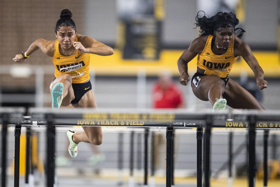 Iowa’s Paige Magee and Myreanna Bebe run in the women’s 60-meter hurdle final during the Hawkeye Invitational at the University of Iowa Recreation Building in Iowa City on Saturday, Jan. 14, 2023. Bebe set a meet record after finishing first with a time of 8.22. The Hawkeye Invitational hosted Ball State, Bradley, Indian Hills, Iowa, Iowa Central, Missouri, Northern Iowa, Western Illinois, Wis.-River Falls, and unattached individuals.