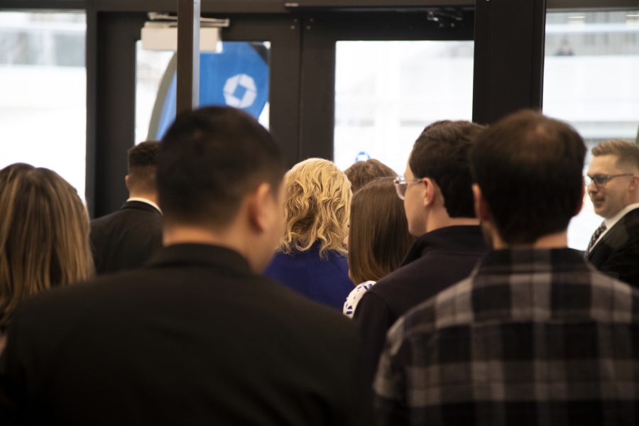 Employees head outside to cut the ribbon during a ceremony at Chase Bank in downtown Iowa City Wednesday, Jan. 17, 2023. (Matt Sindt/The Daily Iowan)