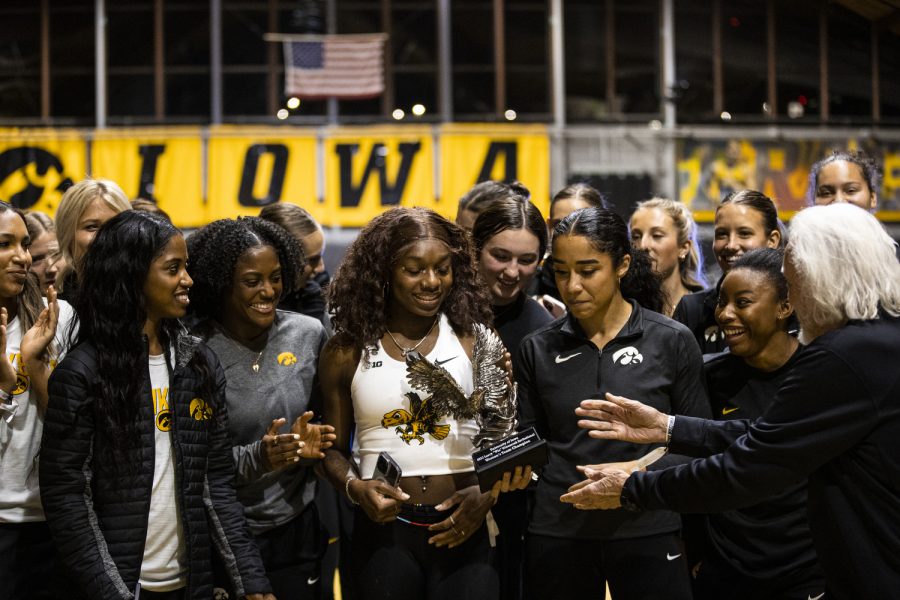 The Iowa women’s track and field team celebrates with a trophy for winning the team competition during the Larry Wieczorek Invitational at the Iowa Indoor Track Facility in Iowa City on Saturday, Jan. 21, 2023. The meet also hosted the Hawkeye Pro Classic for the American Track League.