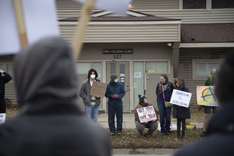 Pro-choice protesters stand in front of the Emma Goldman Clinic during an abortion protest and counter protest outside of the Emma Goldman Clinic in Iowa City on Saturday, Jan. 21, 2023. (Matt Sindt/The Daily Iowan)