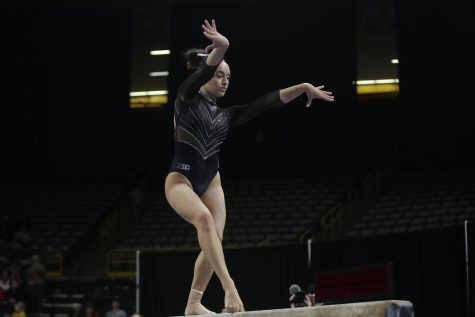 Iowa gymnast Karina Muñoz competes on the beam during a gymnastics meet between Iowa and Minnesota in Iowa City on Friday, Jan. 27, 2023. The Hawkeyes and the Gophers tied with each getting a 196.875. 