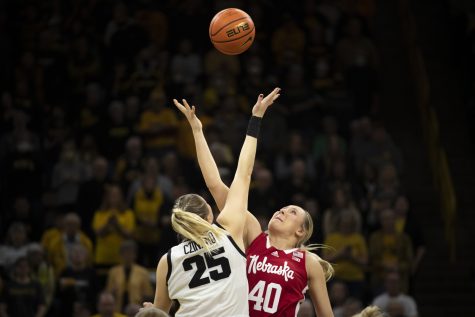 Iowa center Monika Czinano and Nebraska center Alexis Markowski reach for the ball during tip off at a women’s basketball game between No. 10 Iowa and Nebraska at Carver-Hawkeye Arena in Iowa City on Saturday, Jan. 23, 2022. The Hawkeyes defeated the Huskers, 80-76. (Matt Sindt/The Daily Iowan)
