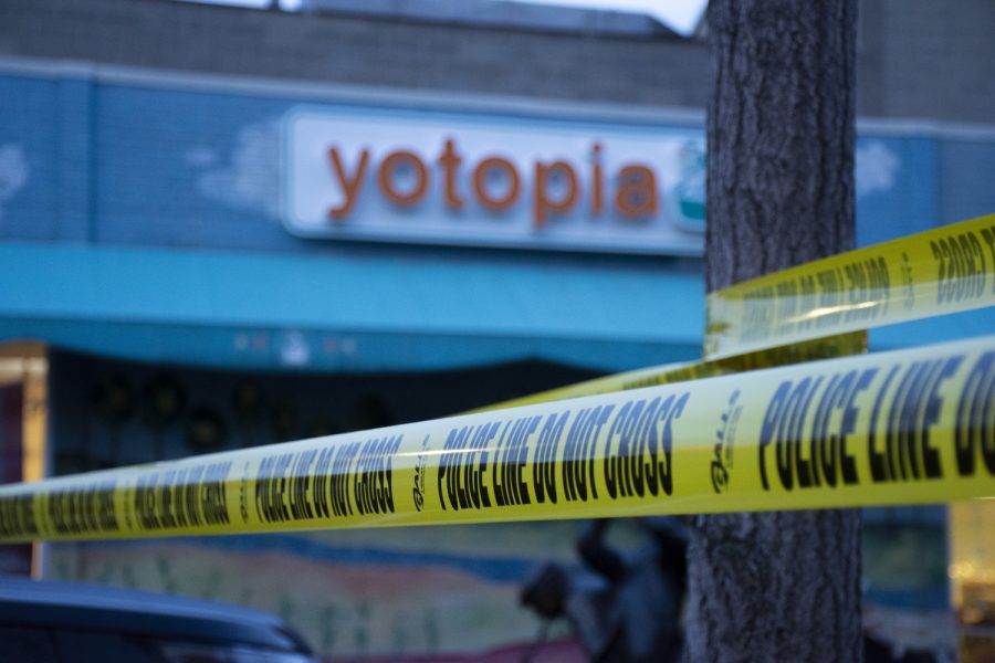 Police tape is seen near the entrance of Yotopia after reports of shots fired near the Pedestrian Mall on in Iowa City, Iowa on Saturday, Jan. 14, 2023. No one was injured and officers were able to detain the shooter.