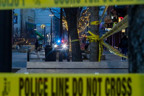 A police car sits near the entrance of Brother’s Bar and Grill after reports of shots fired near the Pedestrian Mall in Iowa City, Iowa on Saturday, Jan. 14, 2023. No one was injured and officers were able to detain the shooter.