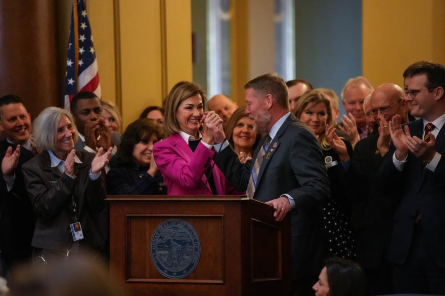Gov.+Kim+Reynolds+high+fives+House+Speaker+Pro+Tempore+John+H.+Wills%2C+R-District+10+before+she+signs+the+House+File+68+in+the+rotunda+of+the+Iowa+State+Capitol+building+on+Tuesday%2C+Jan.+24%2C+2023.