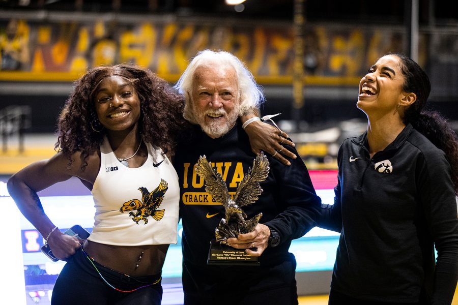 Iowa’s Myreanna Bebe poses for a photo with former Iowa track and field head coach Larry Wieczorek while celebrating with a trophy for winning the team competition during the Larry Wieczorek Invitational at the Iowa Indoor Track Facility in Iowa City on Saturday, Jan. 21, 2023. 