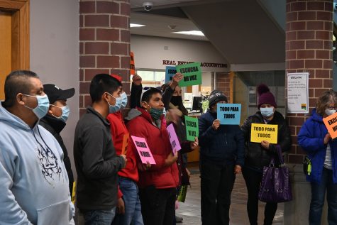 “Excluded No More,” “Escucha Mi Voz,” “Todo Para Todos,” and more signs are seen in the Johnson County Administration Building on January 24, 2022. About 100 protesters were pushing for funding from the Board of Supervisors Joint Entities Meeting.