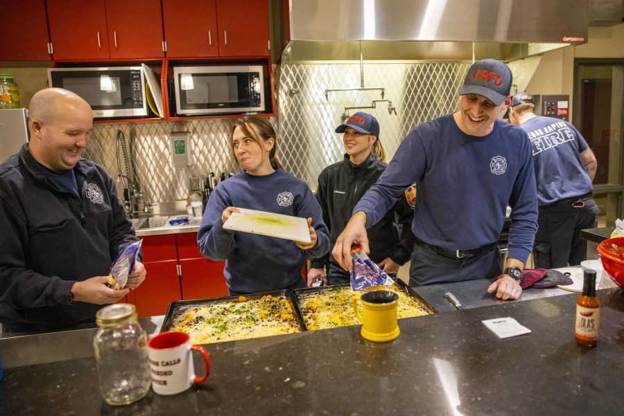 Firefighters Travis Foster, Van Weelden, Wichmann, and McFarlane make nachos for dinner at the Cedar Rapids Central Fire Station on Wednesday, Dec. 7, 2022. Wichmann said the people she works with are what makes the job so special. “The guys and gals that I work with on the daily through my volunteer experience and my professional firefighting experience are the ones that make the job,” Wichmann said. “Just cooking dinner together and running these calls together, doing things outside of the job. Its fulfilling, and I wish everybody could experience something like it.”
