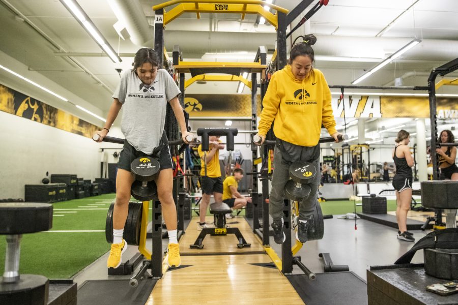 Chun and wrestler Sterling Dias lift weights during a strength and conditioning practice at Carver-Hawkeye Arena in Iowa City, Iowa, on Monday, Nov. 28, 2022. Chun said she enjoys working out with her team and participating in practice drills and activities so she is able to connect on a deeper level with her team.