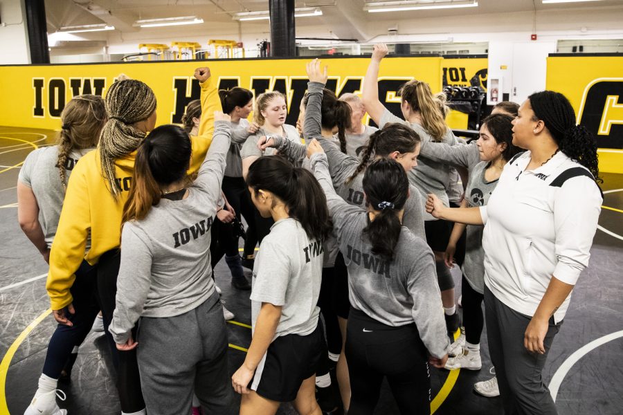 The team huddles up at the end of practice at Carver-Hawkeye Arena in Iowa City, Iowa, on Monday, Nov. 28, 2022. The team’s official schedule and dual meets start next year, but wrestlers are currently competing in tournaments and earning titles. 