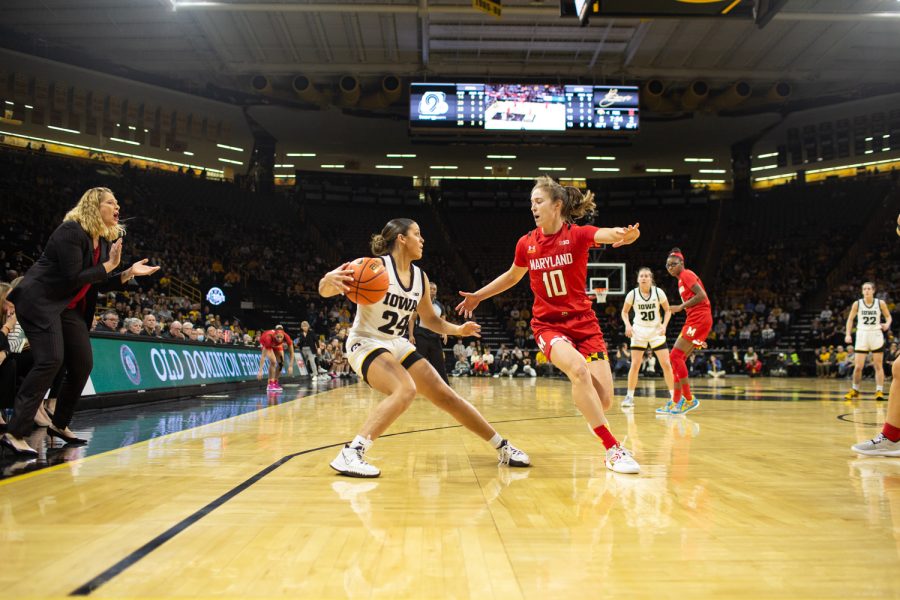 Iowa guard Gabbie Marshall jukes out Maryland guard Abby Meyers during a women’s basketball game between Iowa and Maryland at Carver Hawkeye Arena in Iowa City on Thursday, February 2, 2023. The Hawkeyes defeated the Terrapins, 96-82. 