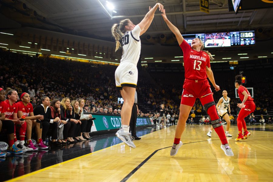 Iowa guard Kate Martin shoots a three while Maryland guard Faith Masonius attempts to block during a womenÕs basketball game between Iowa and Maryland at Carver Hawkeye Arena in Iowa City on Thursday, February 2, 2023. The Hawkeyes defeated the Terrapins, 96-82. 