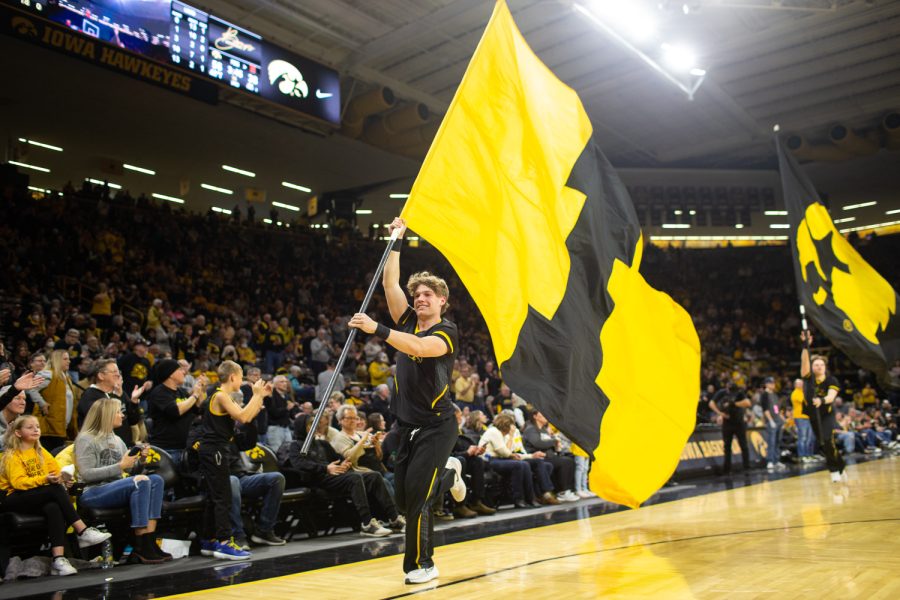 An Iowa cheerleader waves the I flag during a women’s basketball game between Iowa and Maryland at Carver Hawkeye Arena in Iowa City on Thursday, February 2, 2023. The Hawkeyes defeated the Terrapins, 96-82. 