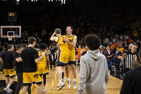 Iowa guards Payton Sandfort and Josh Dix celebrate after a men’s basketball game between Iowa and Illinois at Carver-Hawkeye Arena in Iowa City on Saturday, Feb. 4, 2023. The Hawkeyes defeated the Illini, 81-79.